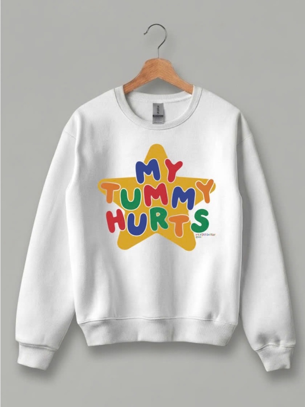 Gildan White Crewneck Sweatshirt with Multicolor 'My Tummy Hurts' Star Graphic